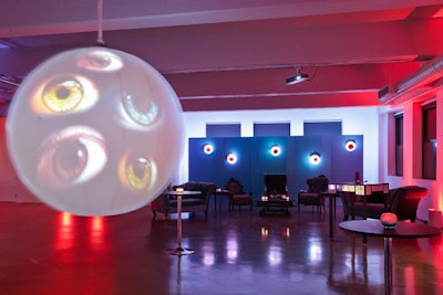 In front of the lounge, projections of blinking eyes showed up on a hanging white orb meant to recall a modern art piece.