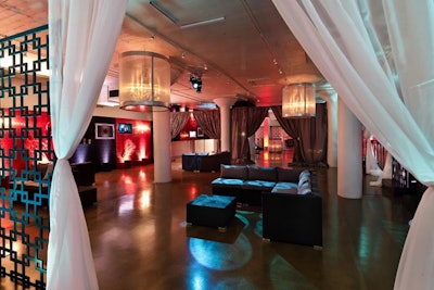 An inverted lounge area included two side-by-side spots. On one side, furniture was on the ground and chandeliers hung from the ceiling.