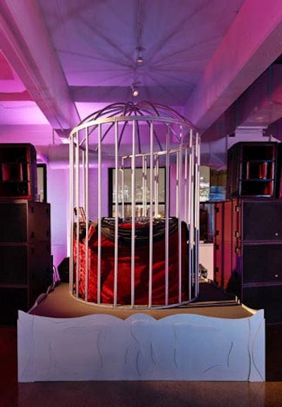 A giant birdcage surrounded the DJ station.