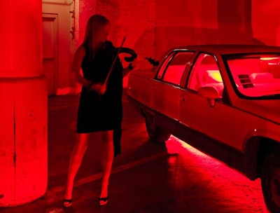 Guests entered via an underground parking lot, where cars were bathed in eerie red lights. Electric violinist Katarina Visnevska provided a live soundtrack for the cinematic scene.