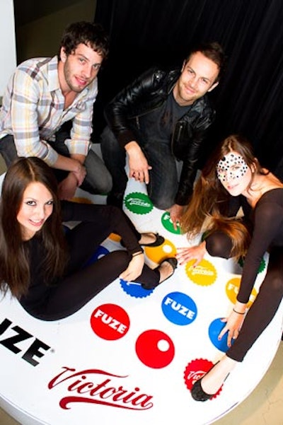 Outside the main party room, guests could pose on a Twister board that bore the logos of sponsors such as Fuze and Victoria. Models posed with the partygoers.