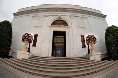 Amaryllis created large floral arrangements in the same colors as those in the event area to flank the venue's doorway.