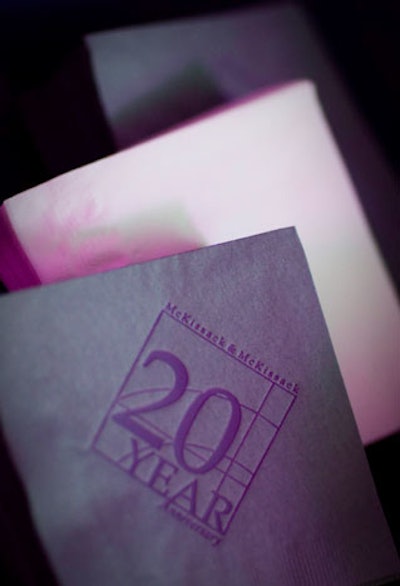 The firm's 20th anniversary logo extended from the menus and napkins to the projections on the screens at each end of the two dinner tables.