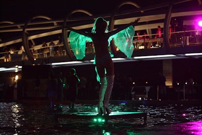 Go-go dancers performed on small platforms in the pool.