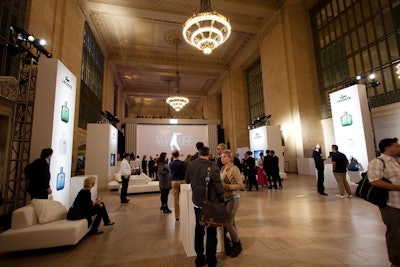 Inside Grand Central Terminal's Vanderbilt Hall on Monday, Lacoste set up a space to house 300 guests for the launch of its Eau de Lacoste L.12.12 fragrance and 'La Machine L.12.12' installation. Stark white furniture complemented the clean contemporary look of the event and matched the brand's overarching aesthetic. While the setup was fairly straightforward, the video system was a bit more complex: The entire event was streamed live via a three-camera setup with a single operator on a tripod-mounted camera and two robotic cameras placed overhead and to the side. “We kept the lighting simple. The idea of the brand has very clean, crisp lines, so we put all our energies into the scenic fabrication and did very clean lighting on that,” said Glow Design Group principal Craig Robillard.