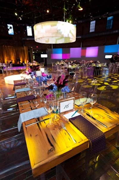 Rectangular dinner tables alternated with round, mirrored tables in the dining area to create an eye-catching mix of materials, colors, and texture.