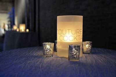 Branded candles illuminated low-slung tables in the cocktail area.