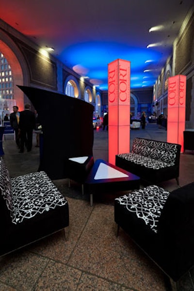 Sleek furniture, floor lamps, and Damask carpet from Cort Event Furnishings lent an indoor feel to the outdoor venue.