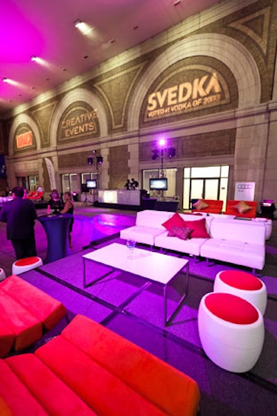 Red and white furniture mirrored the white Audi situated near the lounge, and sponsor logos illuminated the walls.