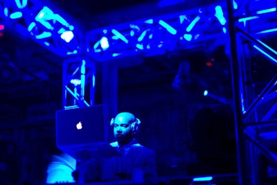 DJ Kaje played inside the truss cube above the bar.