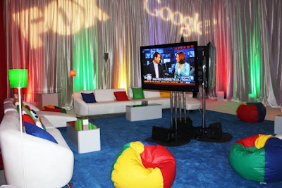 The Event Source created several groupings of white lounge furniture throughout the room. Each area included wide-screen TVs and colorful pillows, and some also had beanbag chairs.