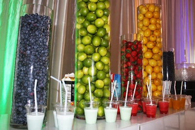 Decorative glass cylinders at the smoothie bar were filled with fruit that complemented the blue, green, red, and yellow accents in the room.