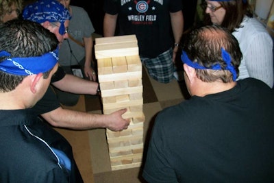 In Wildly Different's 'Building Up Your Savings' activity, teams must play a giant game of Jenga. They earn extra points if they remove a block with a dollar bill on it.