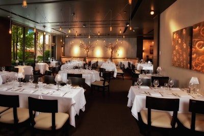 Decor includes custom chrome-plated chandeliers suspended from the main room, as well as black pearl glass pendants and white shell sconces in the private dining area.