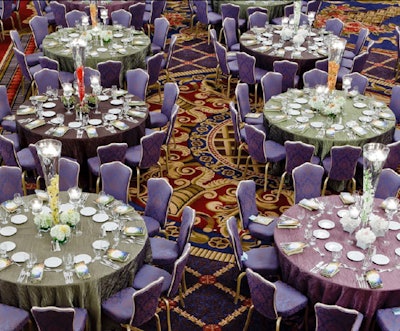 The Cloth Connection provided linens. Centerpieces were towering glass vases with floating candles, submerged orchids, and satellite arrangements.