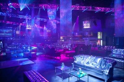 Elaborate lighting and laser displays added to the 'Robotica' theme. Silver, mauve, and turquoise couches and holographic cocktail tables from Luxe Modern Rentals filled Kool Haus.