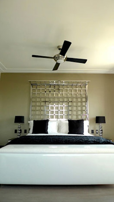 Minimal furnishings and black and white touches decorate a guest suite.