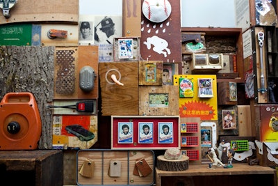 Artist Mac Premo converted the interior of the regulation trash bin to showcase a collection of more than 400 personal objects, including old I.D. cards, tickets to a New York Yankees game on September 11, 2001, and food wrappers.
