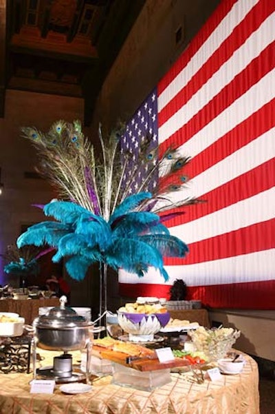 Tall centerpieces of blue plumes and peacock feathers adorned the food stations in the main event space.