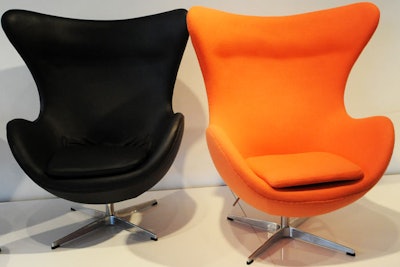 The Egg Chair comes in both orange fabric and black leather. The shapely chair is an Arne Jacobsen design from 1958.