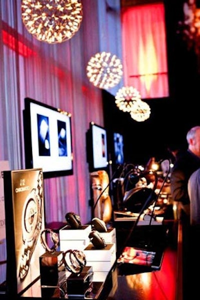 Luxury brand representatives chatted with guests in the roped-off Glenlivet Editor's Lounge. Televisions along the wall displayed pages from The Book For Men.