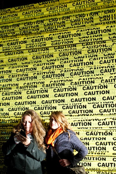 Guests pose in and in front of yellow caution tape at Barricades, reminiscent of G20 summit chaos in 2010.