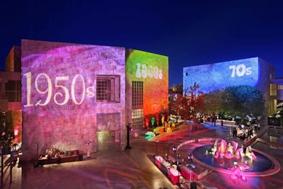 Projections on the museum's walls announced the decades that corresponded to the themes of the buffets and bars below them.