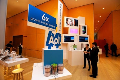 The activation inside Advertising Week's main venue was simple, with clean lines, white tables, and pops of color to highlight key statistics from AOL properties. The colorful signs stood atop small booths, which offered free pens, candy, and electronic device chargers.