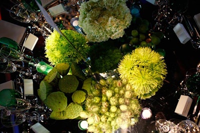 Color-themed florals decorated the dinner tabletops, groupings of blue and green hues and dahlias in an array of shades.The green arrangements (pictured) consisted of such elements as spider mums, bells of Ireland, figs, artichokes, succulents, asclepias, poppy pods, and lotus pods.