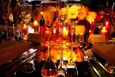 Event producer Bronson van Wyck countered the venue's gritty and rough aesthetic by bringing in opposing elements, incorporating smooth, hard, and shiny surfaces like mirrored tabletops at the dinner.