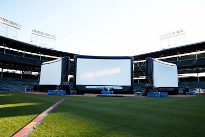 The film was broadcast on three inflatable screens, each 20 feet high by 30 feet wide. Staffers strapped water barrels to the bases of the screens to keep them weighted down on the windy day.