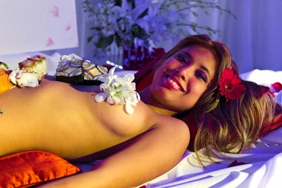 In addition to serving food, Dragonfly restaurant displayed what it calls 'naked sushi': a reclining woman decorated with flowers and pieces of sushi. The display is one of the restaurant's options for catering packages.
