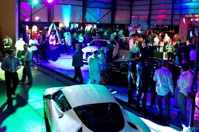 Guests mingled among dozens of luxury automobiles, planes, boats, motorcycles, and consumer products.