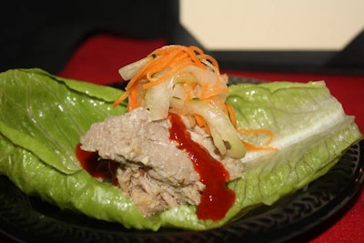 Dragonfly restaurant served braised pork shoulder in dashi mojo marinade atop a lettuce leaf. Servers topped it with a salad of pickled cucumbers and carrots, and red chili paste.
