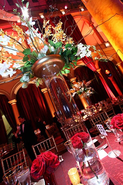 Suzanne Codi Floral Design mixed elevated floral arrangements with short bouquets of red roses on some of the dinner tables at the museum.