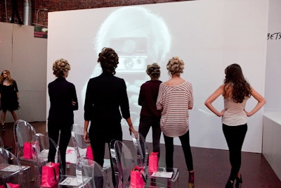 In an arty installation, models posed for a projected image of a photographer.