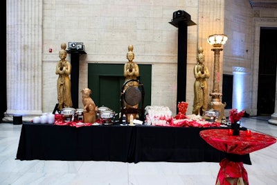 The Chinatown food station held egg rolls, potstickers, chicken Kung Pao, and sesame soba noodles. Decor included golden statues and silky red linens with embroidered flowers.