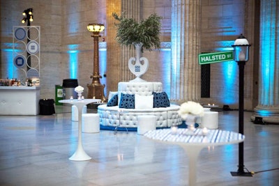 Tufted white lounge furniture, blue accents, and a towering floral arrangement channeled Greektown in one area of the reception.