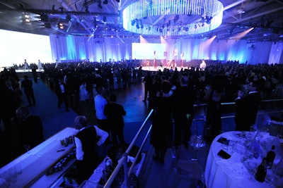 The 116-foot-long stage and runway was backed by large screens. A circular lighting truss lit the centre stage. V.I.P. guests got prime views of the performances from raised platforms.