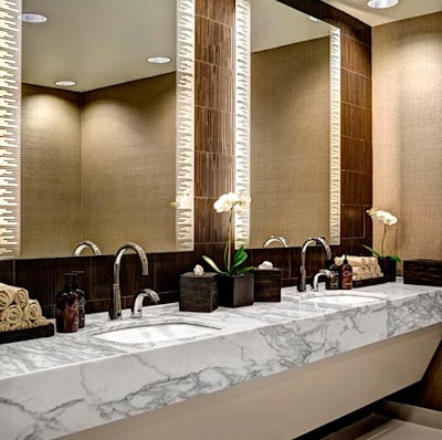 Decorative touches in the locker rooms include bamboo wall coverings, marble fixtures, and white orchids.