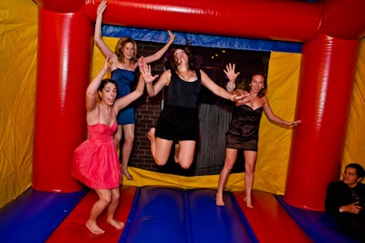 Outside, guests let loose in the bouncy castle.