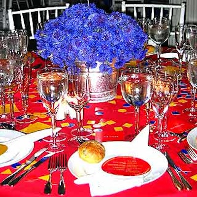 Inside the Metropolitan Pavilion, the dining room glowed with a whimsical decor scheme that employed primary colors and steel bucketfuls of bachelor button flowers for centerpieces.