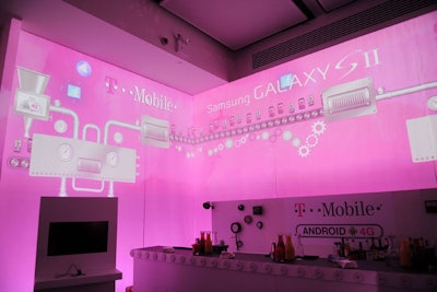 Inside, each wall was filled with projected imagery, which formed a futuristic factory-like setting using T-Mobile's magenta color. Animated projections like a conveyor belt incorporated actions made by guests using the new 4G devices.