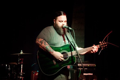 David Miller, lead singer of bluegrass-and-country-fusion band Los Bastardos Magnificos, played guitar for the audience.
