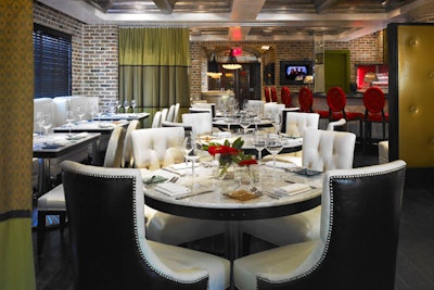 Vic & Angelo's private dining area features white-upholstered furnishings.