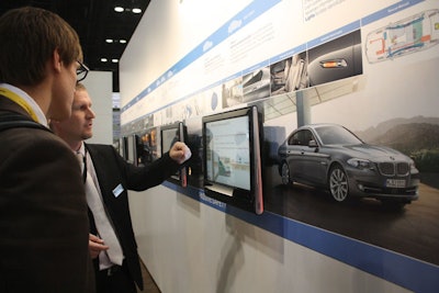 BMW mounted four monitors along a wall at its booth to demonstrate its integrated safety features.