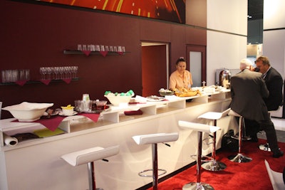 Siemens created several sections within its large booth, including a six-seat coffee bar along the back wall. There were also tables for networking, touch screens for demonstrations, and an enclosed room for meetings.
