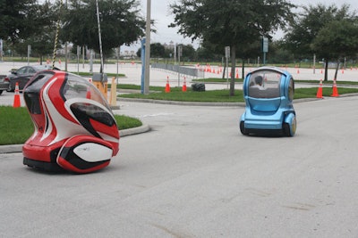 In the convention center parking lot, attendees could try General Motors's two-seat electric concept vehicle, the EN-V.