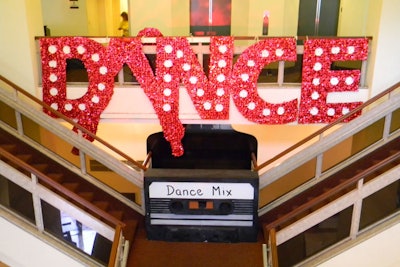 A large foam cassette tape stood at the staircase under an illuminated sign at the Deja Vu Gala hosted by Big Brothers Big Sisters of Broward County.