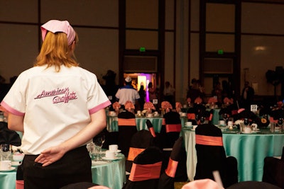 Kirby Rental Services decorated the tables with satin linens and coral napkins to give the room a retro vibe.